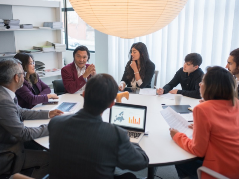 group of people sitting around a table (research panel post)