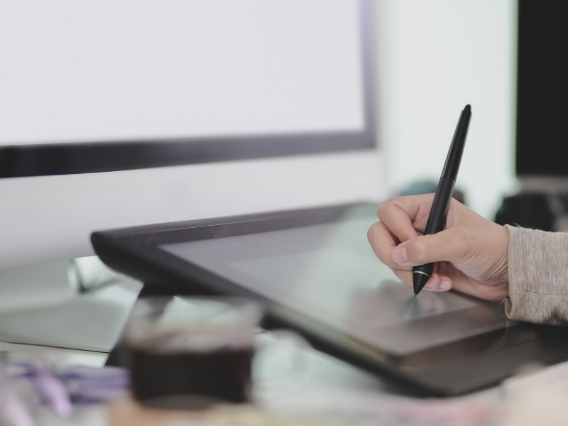 image of person writing on computer screen (accessible survey post)